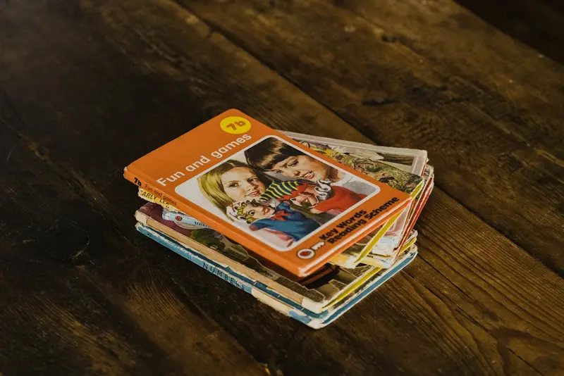 A short stack of trading cards on a wooden tabletop