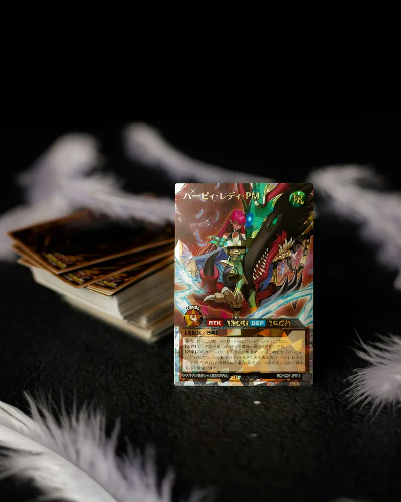 A Japanese-language trading card propped in front of a stack of cards